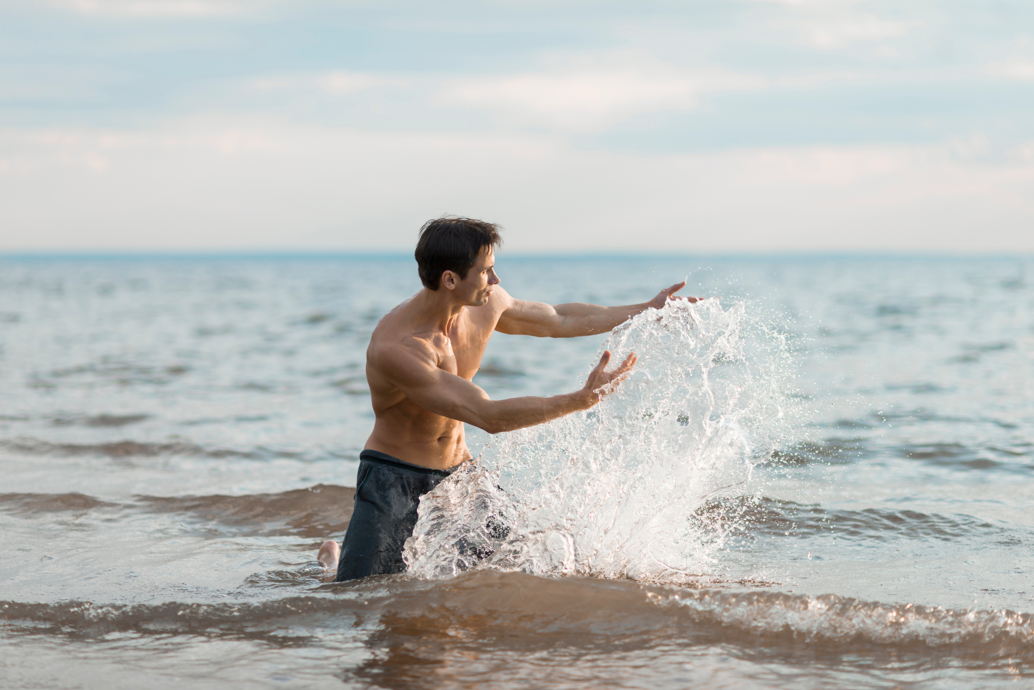 man paying with ocean waves
