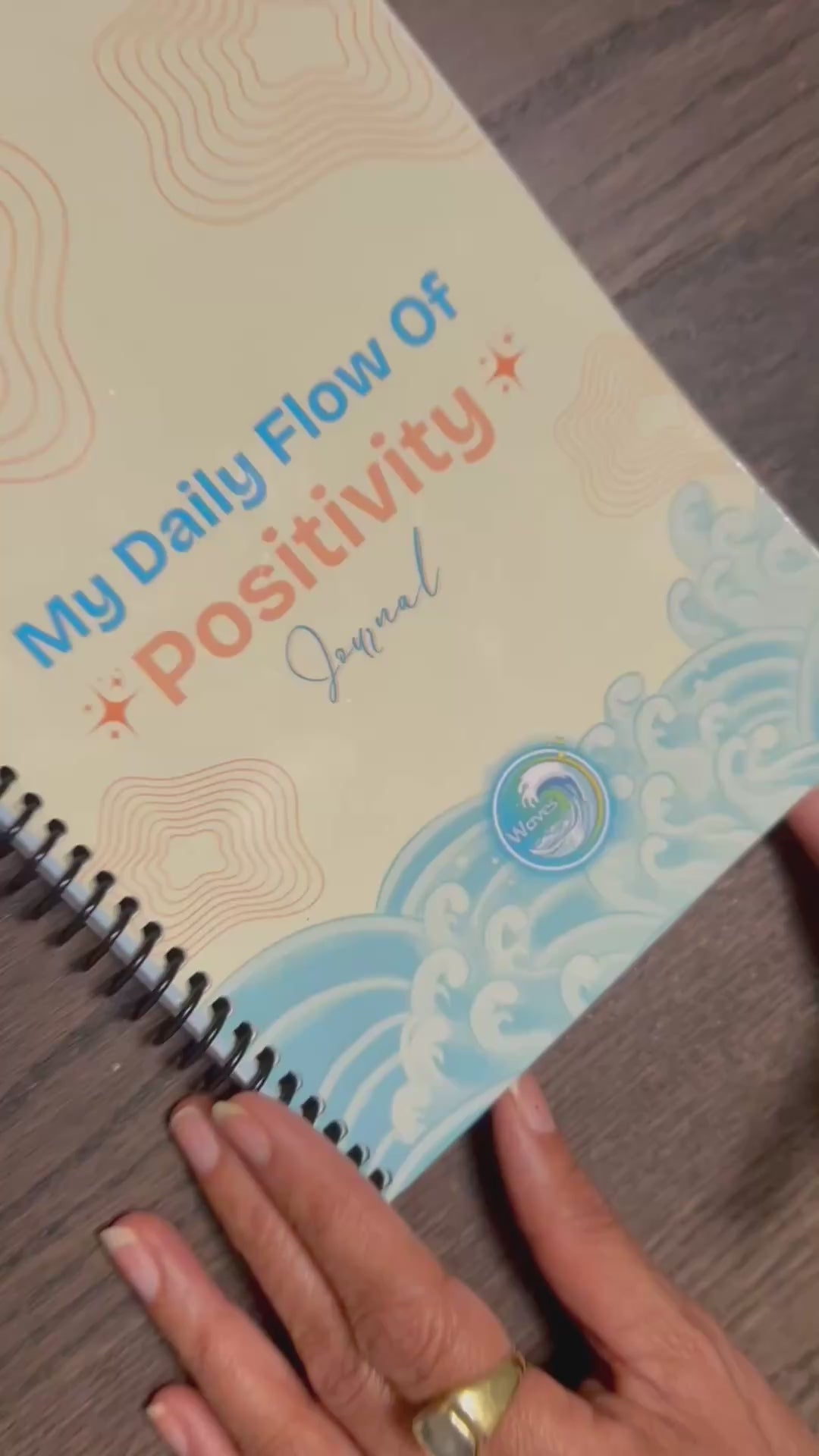 Flow Wellness Journal | Daily Wellbeing, Growth, Happiness - Simple, Sustainable - US/Uk/Canada shipping --Open spiral-bound video of journal with someone writing in a daily page
